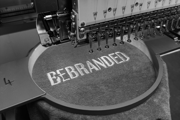 photo of Logo being embroidered on an embroidery machine
